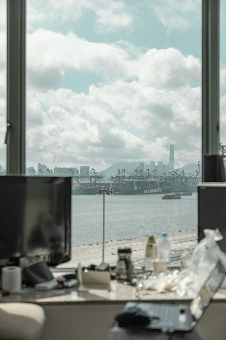 A large cargo ship is docked at an industrial port.